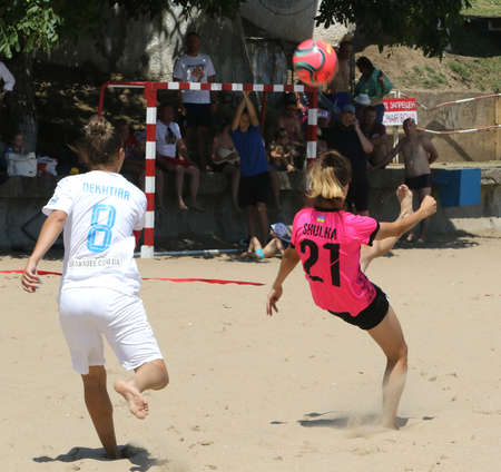 ODESSA, UKRAINE July 8, 2021: Ukrainian Beach Soccer Women's Cup. The girl's footballers are desperately playing beach soccer on sand of sea city beach on a hot sunny day. Women's soccer on sandのeditorial素材