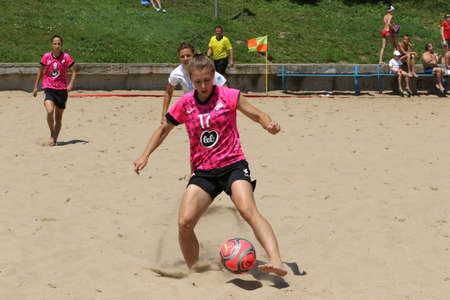 ODESSA, UKRAINE July 8, 2021: Ukrainian Beach Soccer Women's Cup. The girl's footballers are desperately playing beach soccer on sand of sea city beach on a hot sunny day. Women's soccer on sandのeditorial素材