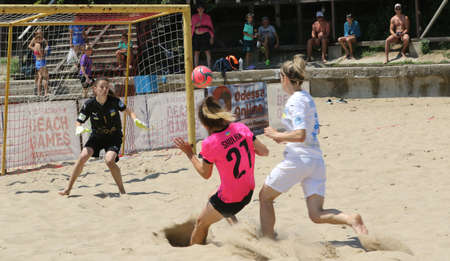 ODESSA, UKRAINE July 8, 2021: Ukrainian Beach Soccer Women's Cup. The girl's footballers are desperately playing beach soccer on sand of sea city beach on a hot sunny day. Women's soccer on sandのeditorial素材