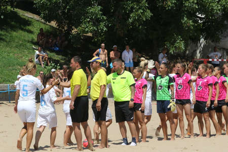 ODESSA, UKRAINE July 8, 2021: Ukrainian Beach Soccer Women's Cup. The girl's footballers are desperately playing beach soccer on sand of sea city beach on a hot sunny day. Women's soccer on sandのeditorial素材