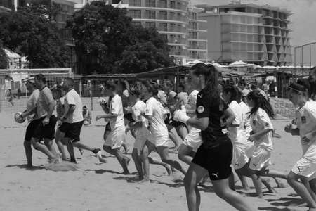 ODESSA, UKRAINE July 8, 2021: Ukrainian Beach Soccer Women's Cup. The girl's footballers are desperately playing beach soccer on sand of sea city beach on a hot sunny day. Women's soccer on sandのeditorial素材