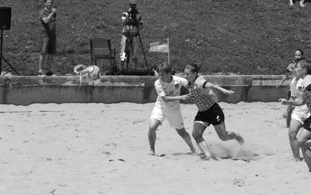 ODESSA, UKRAINE July 8, 2021: Ukrainian Beach Soccer Women's Cup. The girl's footballers are desperately playing beach soccer on sand of sea city beach on a hot sunny day. Women's soccer on sandのeditorial素材