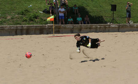 ODESSA, UKRAINE July 8, 2021: Ukrainian Beach Soccer Women's Cup. The girl's footballers are desperately playing beach soccer on sand of sea city beach on a hot sunny day. Women's soccer on sandのeditorial素材