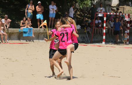 ODESSA, UKRAINE July 8, 2021: Ukrainian Beach Soccer Women's Cup. The girl's footballers are desperately playing beach soccer on sand of sea city beach on a hot sunny day. Women's soccer on sandのeditorial素材