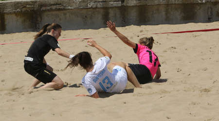 ODESSA, UKRAINE July 8, 2021: Ukrainian Beach Soccer Women's Cup. The girl's footballers are desperately playing beach soccer on sand of sea city beach on a hot sunny day. Women's soccer on sandのeditorial素材