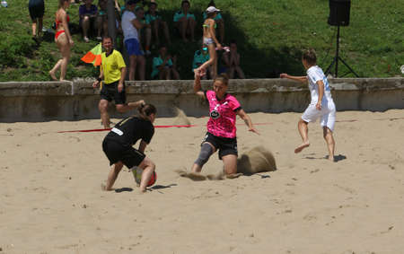 ODESSA, UKRAINE July 8, 2021: Ukrainian Beach Soccer Women's Cup. The girl's footballers are desperately playing beach soccer on sand of sea city beach on a hot sunny day. Women's soccer on sandのeditorial素材