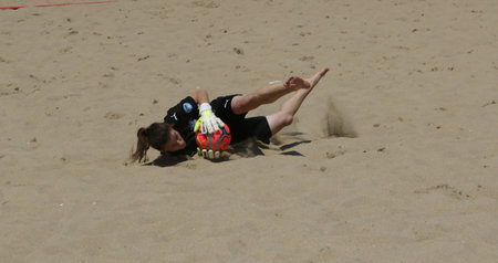 ODESSA, UKRAINE July 8, 2021: Ukrainian Beach Soccer Women's Cup. The girl's footballers are desperately playing beach soccer on sand of sea city beach on a hot sunny day. Women's soccer on sandのeditorial素材