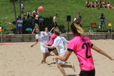 ODESSA, UKRAINE July 8, 2021: Ukrainian Beach Soccer Women's Cup. The girl's footballers are desperately playing beach soccer on sand of sea city beach on a hot sunny day. Women's soccer on sandのeditorial素材