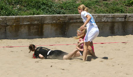 ODESSA, UKRAINE July 8, 2021: Ukrainian Beach Soccer Women's Cup. The girl's footballers are desperately playing beach soccer on sand of sea city beach on a hot sunny day. Women's soccer on sandのeditorial素材