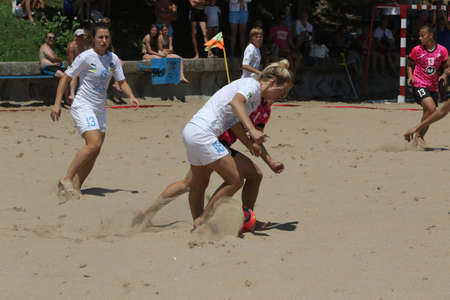 ODESSA, UKRAINE July 8, 2021: Ukrainian Beach Soccer Women's Cup. The girl's footballers are desperately playing beach soccer on sand of sea city beach on a hot sunny day. Women's soccer on sandのeditorial素材