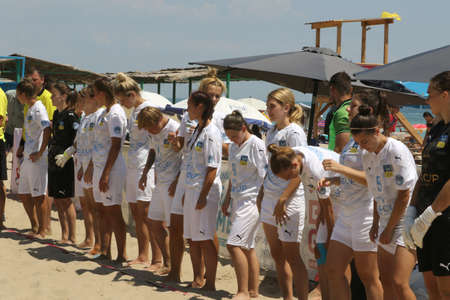 ODESSA, UKRAINE July 8, 2021: Ukrainian Beach Soccer Women's Cup. The girl's footballers are desperately playing beach soccer on sand of sea city beach on a hot sunny day. Women's soccer on sandのeditorial素材