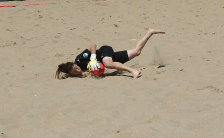 ODESSA, UKRAINE July 8, 2021: Ukrainian Beach Soccer Women's Cup. The girl's footballers are desperately playing beach soccer on sand of sea city beach on a hot sunny day. Women's soccer on sandのeditorial素材