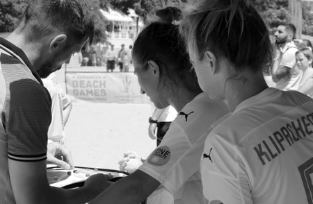 ODESSA, UKRAINE July 8, 2021: Ukrainian Beach Soccer Women's Cup. The girl's footballers are desperately playing beach soccer on sand of sea city beach on a hot sunny day. Women's soccer on sandのeditorial素材