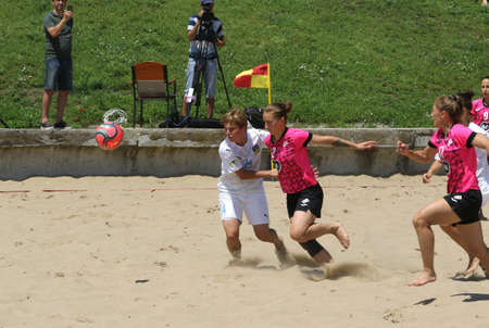 ODESSA, UKRAINE July 8, 2021: Ukrainian Beach Soccer Women's Cup. The girl's footballers are desperately playing beach soccer on sand of sea city beach on a hot sunny day. Women's soccer on sandのeditorial素材
