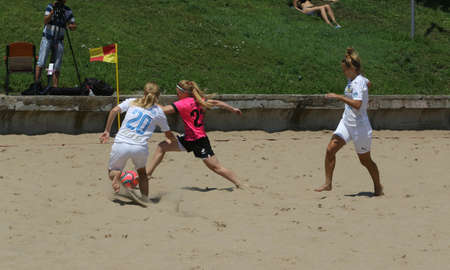 ODESSA, UKRAINE July 8, 2021: Ukrainian Beach Soccer Women's Cup. The girl's footballers are desperately playing beach soccer on sand of sea city beach on a hot sunny day. Women's soccer on sandのeditorial素材
