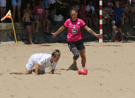 ODESSA, UKRAINE July 8, 2021: Ukrainian Beach Soccer Women's Cup. The girl's footballers are desperately playing beach soccer on sand of sea city beach on a hot sunny day. Women's soccer on sandのeditorial素材