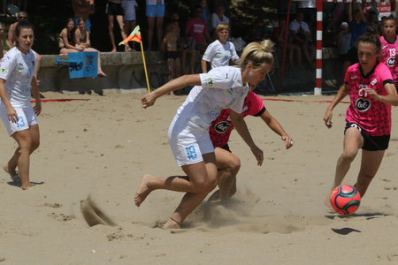 ODESSA, UKRAINE July 8, 2021: Ukrainian Beach Soccer Women's Cup. The girl's footballers are desperately playing beach soccer on sand of sea city beach on a hot sunny day. Women's soccer on sandのeditorial素材