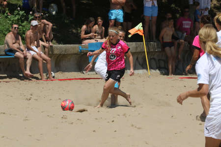 ODESSA, UKRAINE July 8, 2021: Ukrainian Beach Soccer Women's Cup. The girl's footballers are desperately playing beach soccer on sand of sea city beach on a hot sunny day. Women's soccer on sandのeditorial素材