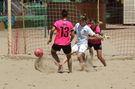 ODESSA, UKRAINE July 8, 2021: Ukrainian Beach Soccer Women's Cup. The girl's footballers are desperately playing beach soccer on sand of sea city beach on a hot sunny day. Women's soccer on sandのeditorial素材