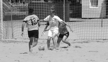 ODESSA, UKRAINE July 8, 2021: Ukrainian Beach Soccer Women's Cup. The girl's footballers are desperately playing beach soccer on sand of sea city beach on a hot sunny day. Women's soccer on sandのeditorial素材