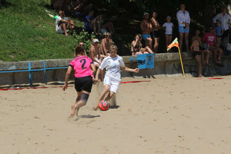 ODESSA, UKRAINE July 8, 2021: Ukrainian Beach Soccer Women's Cup. The girl's footballers are desperately playing beach soccer on sand of sea city beach on a hot sunny day. Women's soccer on sandのeditorial素材