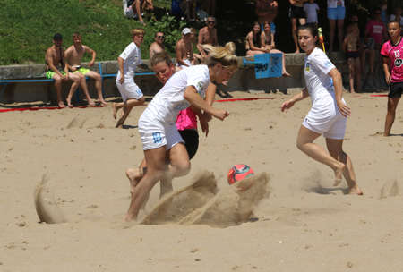 ODESSA, UKRAINE July 8, 2021: Ukrainian Beach Soccer Women's Cup. The girl's footballers are desperately playing beach soccer on sand of sea city beach on a hot sunny day. Women's soccer on sandのeditorial素材