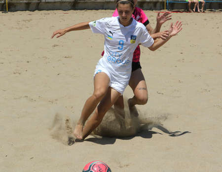 ODESSA, UKRAINE July 8, 2021: Ukrainian Beach Soccer Women's Cup. The girl's footballers are desperately playing beach soccer on sand of sea city beach on a hot sunny day. Women's soccer on sandのeditorial素材