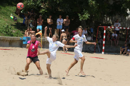 ODESSA, UKRAINE July 8, 2021: Ukrainian Beach Soccer Women's Cup. The girl's footballers are desperately playing beach soccer on sand of sea city beach on a hot sunny day. Women's soccer on sandのeditorial素材