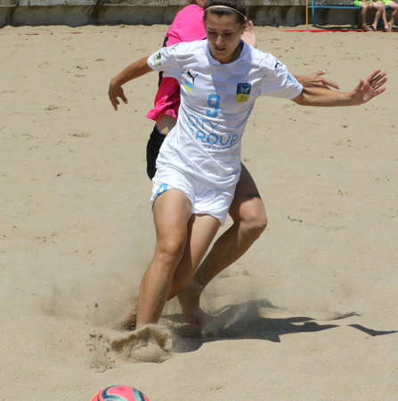 ODESSA, UKRAINE July 8, 2021: Ukrainian Beach Soccer Women's Cup. The girl's footballers are desperately playing beach soccer on sand of sea city beach on a hot sunny day. Women's soccer on sandのeditorial素材