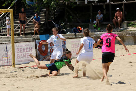 ODESSA, UKRAINE July 8, 2021: Ukrainian Beach Soccer Women's Cup. The girl's footballers are desperately playing beach soccer on sand of sea city beach on a hot sunny day. Women's soccer on sandのeditorial素材