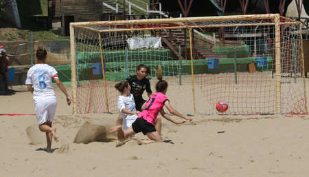ODESSA, UKRAINE July 8, 2021: Ukrainian Beach Soccer Women's Cup. The girl's footballers are desperately playing beach soccer on sand of sea city beach on a hot sunny day. Women's soccer on sandのeditorial素材