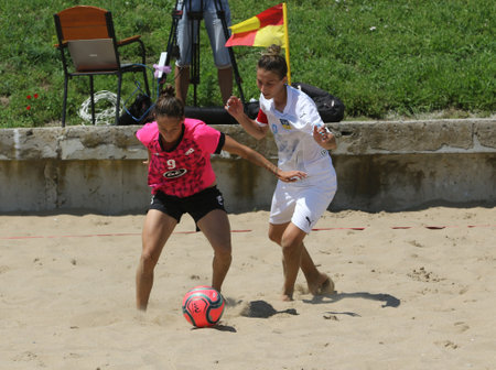 ODESSA, UKRAINE July 8, 2021: Ukrainian Beach Soccer Women's Cup. The girl's footballers are desperately playing beach soccer on sand of sea city beach on a hot sunny day. Women's soccer on sandのeditorial素材