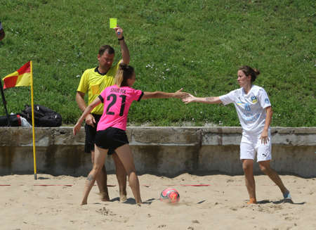 ODESSA, UKRAINE July 8, 2021: Ukrainian Beach Soccer Women's Cup. The girl's footballers are desperately playing beach soccer on sand of sea city beach on a hot sunny day. Women's soccer on sandのeditorial素材