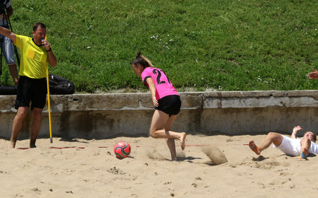 ODESSA, UKRAINE July 8, 2021: Ukrainian Beach Soccer Women's Cup. The girl's footballers are desperately playing beach soccer on sand of sea city beach on a hot sunny day. Women's soccer on sandのeditorial素材