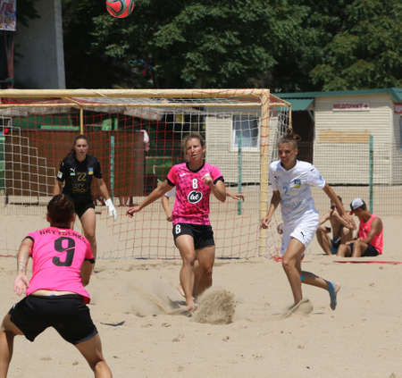 ODESSA, UKRAINE July 8, 2021: Ukrainian Beach Soccer Women's Cup. The girl's footballers are desperately playing beach soccer on sand of sea city beach on a hot sunny day. Women's soccer on sandのeditorial素材