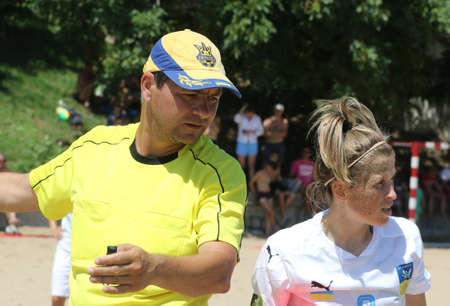 ODESSA, UKRAINE July 8, 2021: Ukrainian Beach Soccer Women's Cup. The girl's footballers are desperately playing beach soccer on sand of sea city beach on a hot sunny day. Women's soccer on sandのeditorial素材