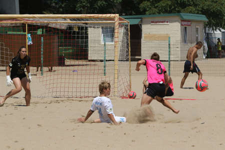 ODESSA, UKRAINE July 8, 2021: Ukrainian Beach Soccer Women's Cup. The girl's footballers are desperately playing beach soccer on sand of sea city beach on a hot sunny day. Women's soccer on sandのeditorial素材