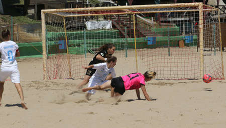 ODESSA, UKRAINE July 8, 2021: Ukrainian Beach Soccer Women's Cup. The girl's footballers are desperately playing beach soccer on sand of sea city beach on a hot sunny day. Women's soccer on sandのeditorial素材