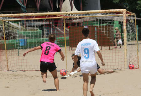 ODESSA, UKRAINE July 8, 2021: Ukrainian Beach Soccer Women's Cup. The girl's footballers are desperately playing beach soccer on sand of sea city beach on a hot sunny day. Women's soccer on sandのeditorial素材