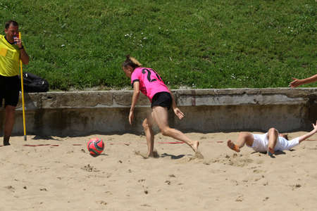 ODESSA, UKRAINE July 8, 2021: Ukrainian Beach Soccer Women's Cup. The girl's footballers are desperately playing beach soccer on sand of sea city beach on a hot sunny day. Women's soccer on sandのeditorial素材