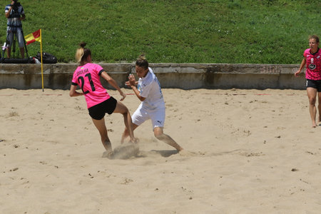 ODESSA, UKRAINE July 8, 2021: Ukrainian Beach Soccer Women's Cup. The girl's footballers are desperately playing beach soccer on sand of sea city beach on a hot sunny day. Women's soccer on sandのeditorial素材