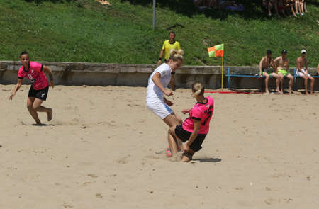 ODESSA, UKRAINE July 8, 2021: Ukrainian Beach Soccer Women's Cup. The girl's footballers are desperately playing beach soccer on sand of sea city beach on a hot sunny day. Women's soccer on sandのeditorial素材