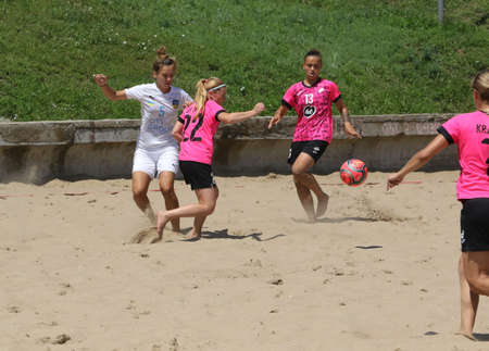 ODESSA, UKRAINE July 8, 2021: Ukrainian Beach Soccer Women's Cup. The girl's footballers are desperately playing beach soccer on sand of sea city beach on a hot sunny day. Women's soccer on sandのeditorial素材