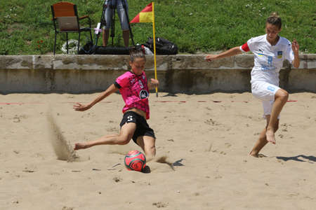 ODESSA, UKRAINE July 8, 2021: Ukrainian Beach Soccer Women's Cup. The girl's footballers are desperately playing beach soccer on sand of sea city beach on a hot sunny day. Women's soccer on sandのeditorial素材