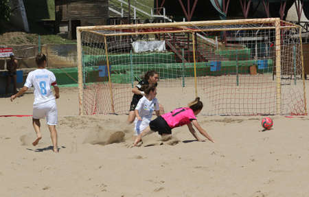 ODESSA, UKRAINE July 8, 2021: Ukrainian Beach Soccer Women's Cup. The girl's footballers are desperately playing beach soccer on sand of sea city beach on a hot sunny day. Women's soccer on sandのeditorial素材