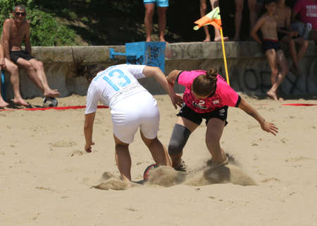 ODESSA, UKRAINE July 8, 2021: Ukrainian Beach Soccer Women's Cup. The girl's footballers are desperately playing beach soccer on sand of sea city beach on a hot sunny day. Women's soccer on sandのeditorial素材
