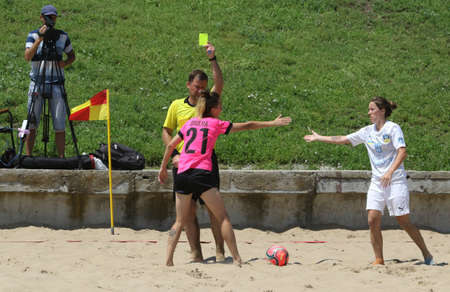 ODESSA, UKRAINE July 8, 2021: Ukrainian Beach Soccer Women's Cup. The girl's footballers are desperately playing beach soccer on sand of sea city beach on a hot sunny day. Women's soccer on sandのeditorial素材