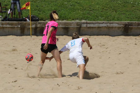 ODESSA, UKRAINE July 8, 2021: Ukrainian Beach Soccer Women's Cup. The girl's footballers are desperately playing beach soccer on sand of sea city beach on a hot sunny day. Women's soccer on sandのeditorial素材