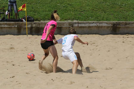 ODESSA, UKRAINE July 8, 2021: Ukrainian Beach Soccer Women's Cup. The girl's footballers are desperately playing beach soccer on sand of sea city beach on a hot sunny day. Women's soccer on sandのeditorial素材