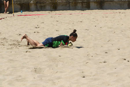 ODESSA, UKRAINE July 8, 2021: Ukrainian Beach Soccer Women's Cup. The girl's footballers are desperately playing beach soccer on sand of sea city beach on a hot sunny day. Women's soccer on sandのeditorial素材